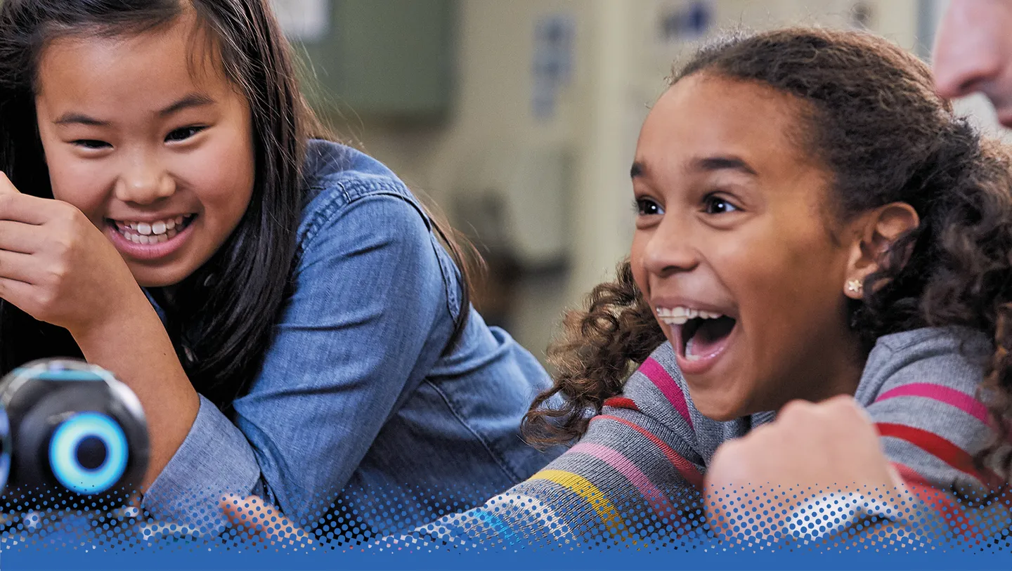 Photo of students in a classroom interacting with technology