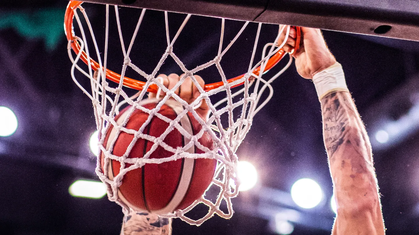 Player dunking a basketball