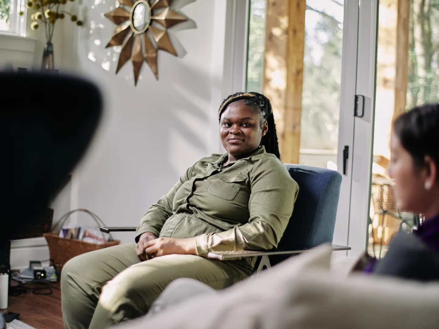 Woman sitting on a chair having a conversation in a living room